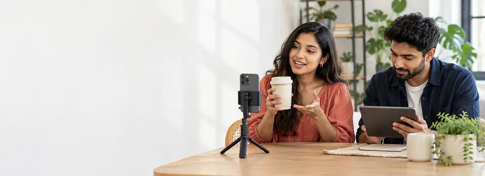 Creator filming a product introduction while a content producer reviews the shoot.